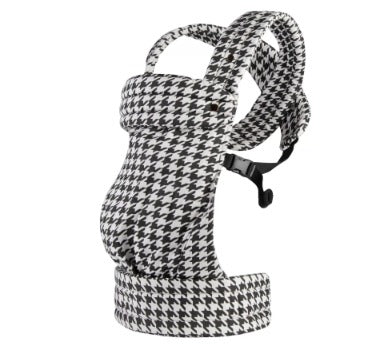 Houndstooth patterned baby carrier with straps on a white background