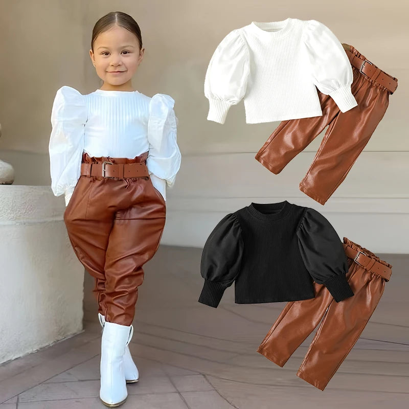 Child wearing a white top with puffed sleeves and brown pants, with additional outfits displayed above.