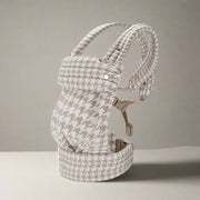 Baby carrier with houndstooth pattern on a white background